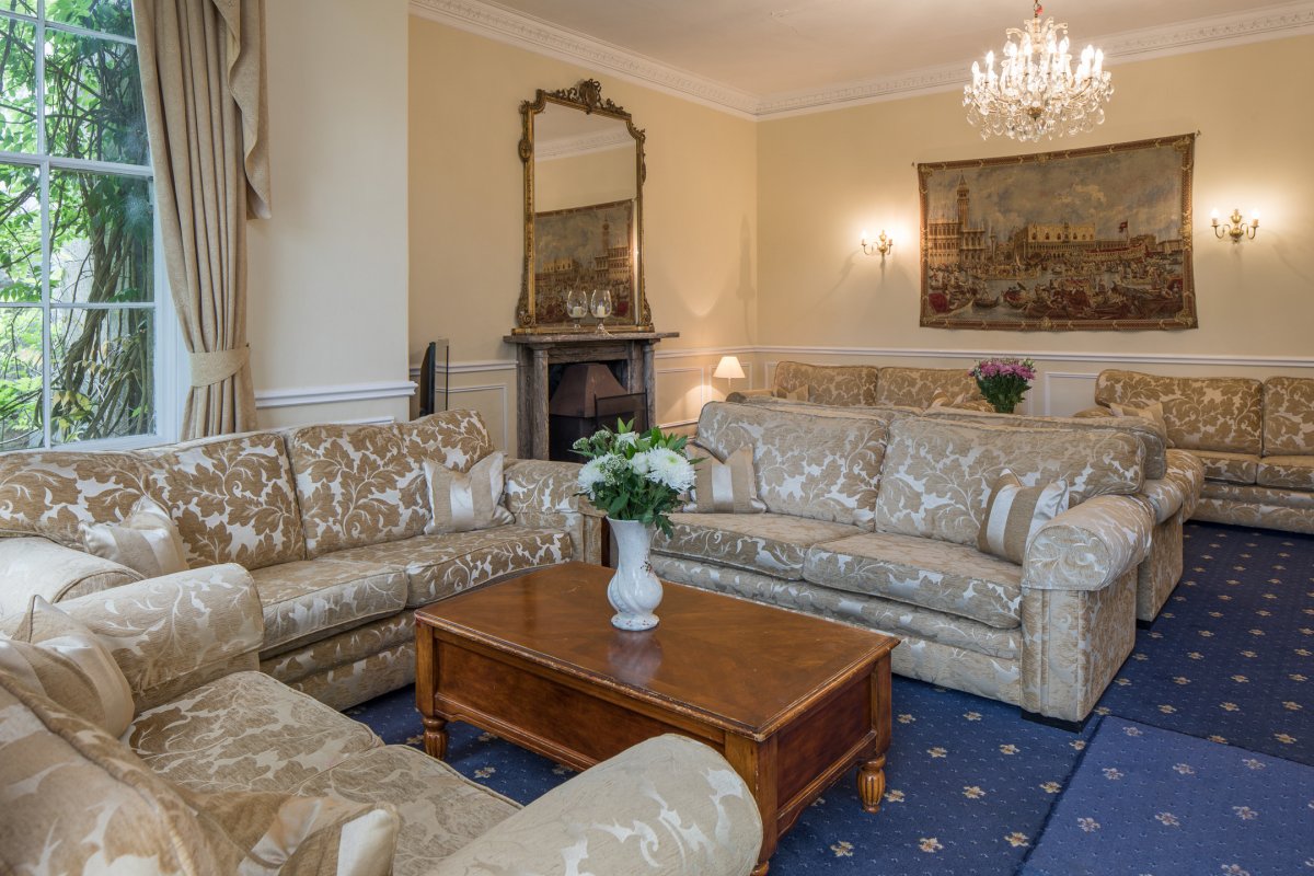 Our spacious living room features a, marble fireplace, Italian tapestries, stunning chandeliers, elegant furniture and French doors leading out to the gardens.